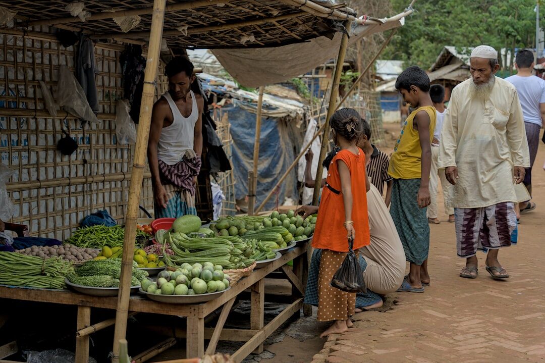 Danish market stall with fresh vegetables and vendor