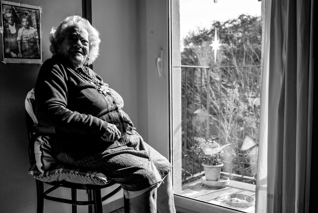 Elderly Danish woman sitting by a window telling her story